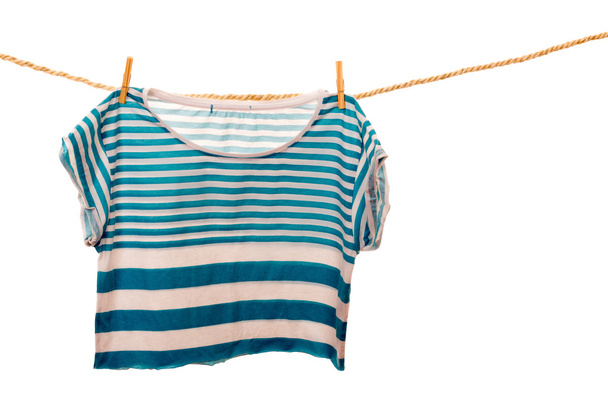blue tshirt hanging on a rope clothesline - 写真・画像
