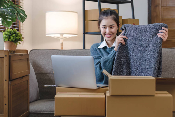 Portrait young attractive asian female owner startup business work happy with box at home prepare parcel delivery in sme supply chain, start up small business concept... - Photo, Image