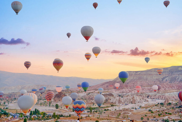 Landscape of fabulous Kapadokya. Colorful flying air balloons in sky at sunrise in Anatolia. Vacations in beautiful destination in Goreme, Turkey  - Zdjęcie, obraz