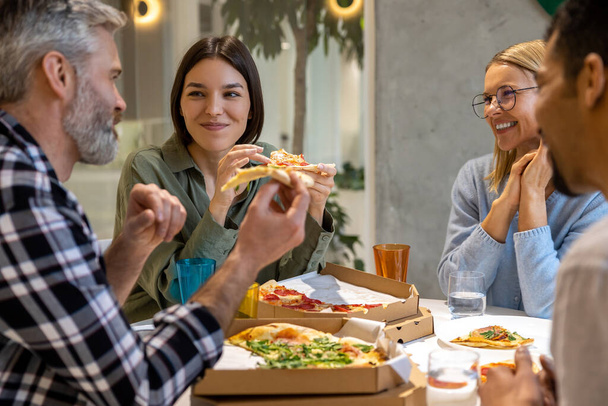 Lunch time. Friends having good time during lunch and enjoying pizza - Foto, Imagem