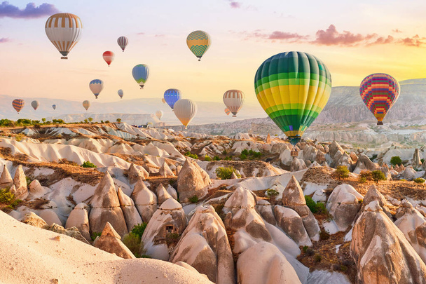 Landscape of scenic valley with colorful flying hot air balloons in Anatolia, Kapadokya. Beautiful destination in Nevsehir, Goreme - Photo, image