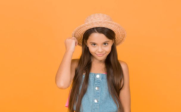 Effortless beauty. beach fashion for kids. small child on yellow background. holiday joy and activity. beauty. long-awaited summer vacation. happy childhood. cheerful little girl wear straw hat. - Photo, image