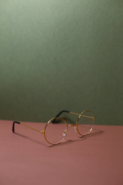 glasses in a thin frame on a plain background - Foto, Bild