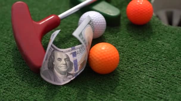 Money, mini golf balls on grass. Concept of sports bet. - Footage, Video