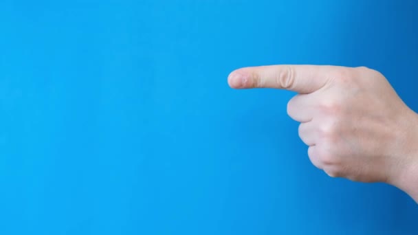 Mans hand gesture on a blue background. Male hand with index finger pointing at something on blue background. Chromakey on a blue screen - Footage, Video