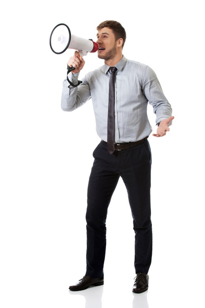 Businessman shouting through megaphone. - Photo, image