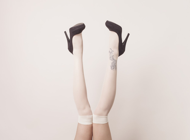 Female legs up in the air wearing stockings - Photo, Image
