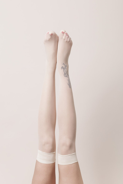 Female legs wearing parisian stockings - Valokuva, kuva