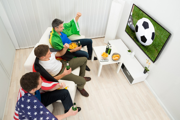 Friends Enjoying Football Game - 写真・画像