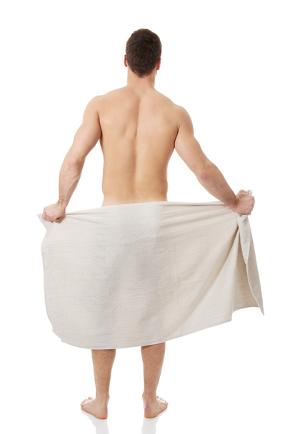 Muscular man wrapped in towel. - 写真・画像
