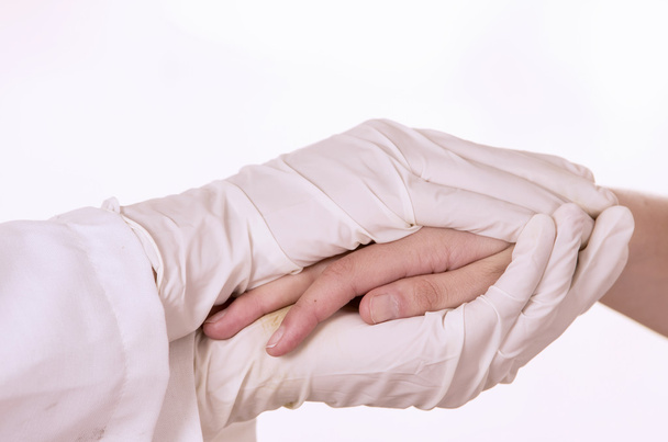 closeup of doctors hands comforting patient - Foto, Bild