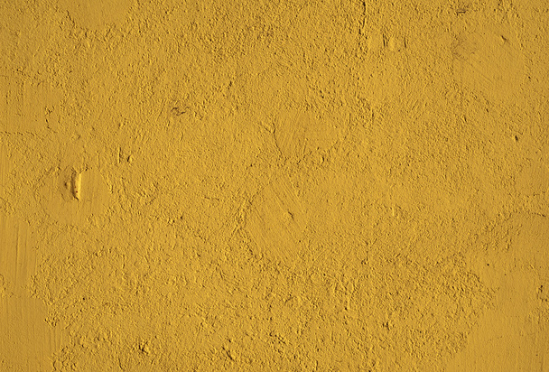 Texture of old wall covered with yellow stucco - Foto, afbeelding