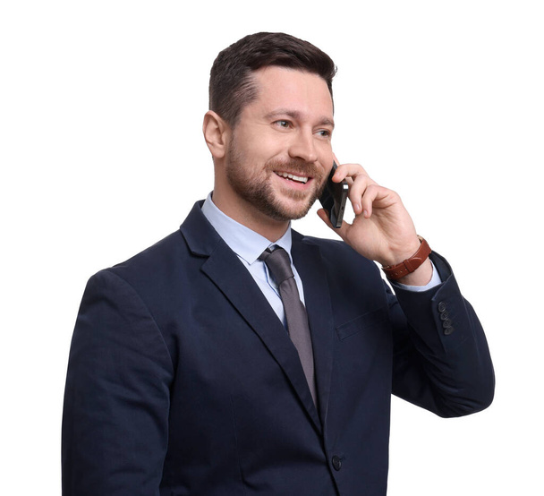 Handsome bearded businessman in suit talking on smartphone against white background - Photo, image