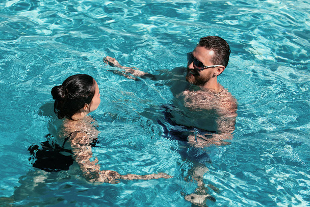 Summer pool resort. Life winner. Couple in pool. Pool party - Foto, imagen
