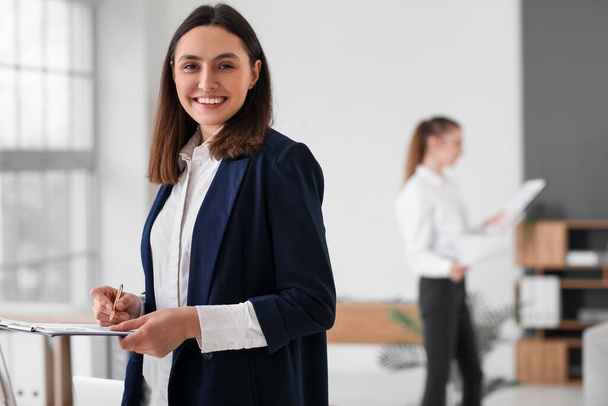 Female accountant with clipboard in office - Photo, Image