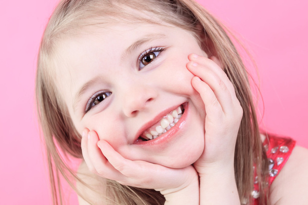 A cute fashion little doll girl in pink background - Zdjęcie, obraz