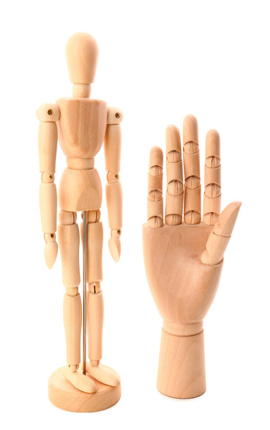Wooden mannequin and hand on white background - Photo, Image