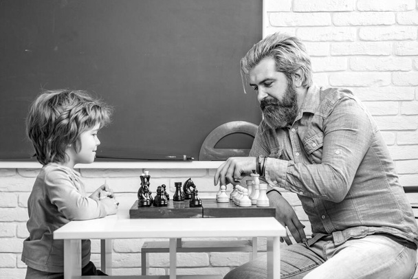 Father teaching his son to play chess. Chess strategy. Chess success and winning. Education and people concept. Happy Fathers day - Zdjęcie, obraz