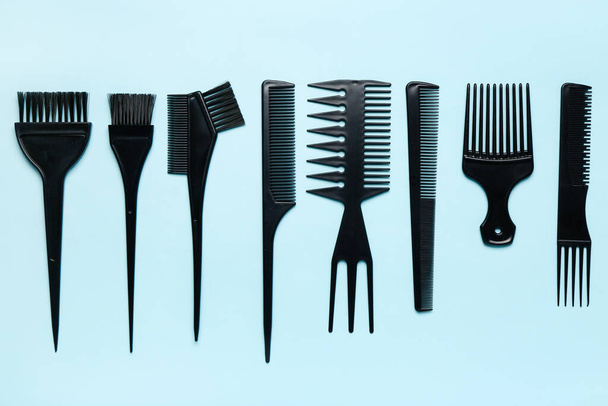 Hairdresser's brushes on blue background - Фото, изображение