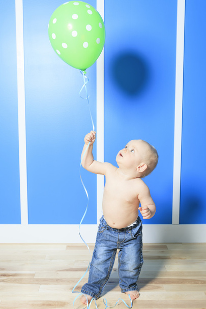 A Boy with colorful balloons in is bedroom - Zdjęcie, obraz