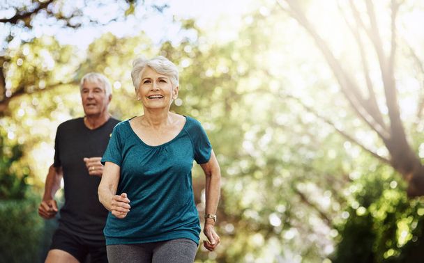 Heading towards a happier and healthier future. a senior couple out for a run together - 写真・画像