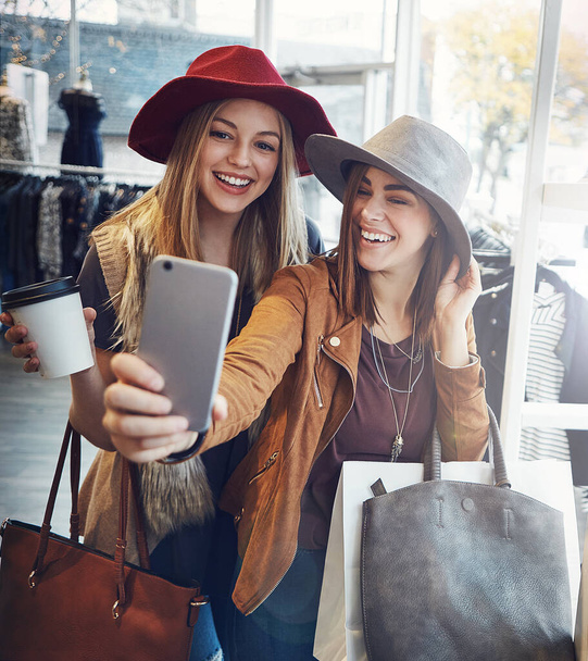 Damn, we look good. two young girlfriends snapping selfies while out on a shopping spree - 写真・画像