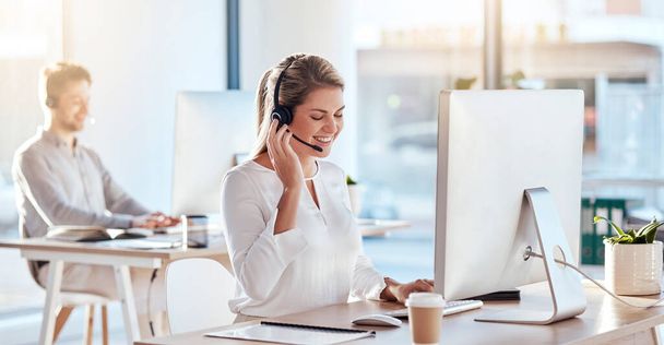Call center, computer and listening with woman in office for customer service, technical support and advice. Technology, contact us and communication with employee operator in help desk agency. - Valokuva, kuva