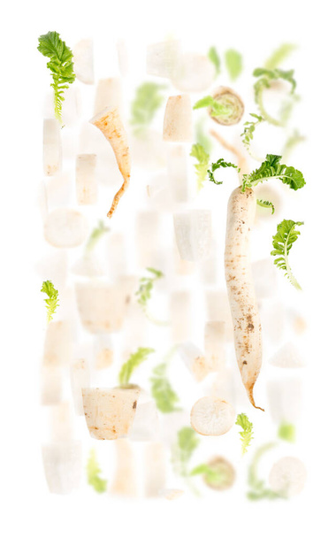 Abstract background made of Parsley root vegetable pieces, slices and leaves isolated on white. - Fotografie, Obrázek