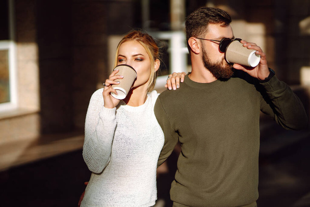 Happy young couple spending time together, drinking coffee, having fun walking around the morning city. Youth, love, time together, lifestyle. - Fotoğraf, Görsel