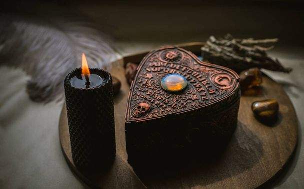 Magical attribute on a table, witchcraft concept, Candle fire, Spells and other rite - Photo, Image