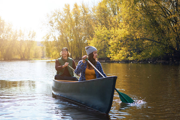 The best way to get around, by boat. a young couple going for a canoe ride on the lake - Photo, Image