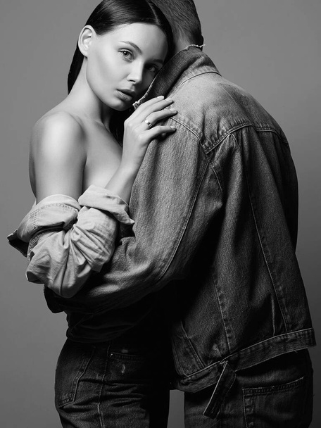 lovely beautiful couple in jeans. sexy woman with Man. boy and girl together. Black and white portrait - Photo, Image