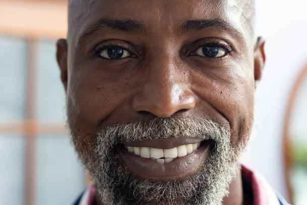 Portrait of happy african american male doctor looking at camera and smiling at doctor's office. Hospital, medicine and healthcare. - Photo, image