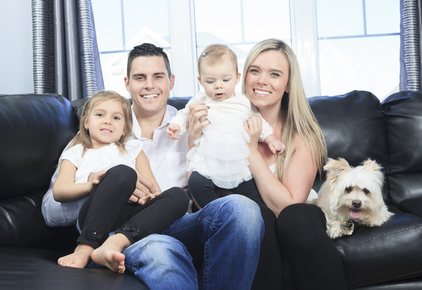 A Family with pets sit on sofa at home - Foto, immagini