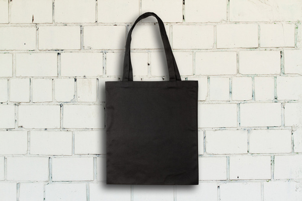 Fabric bag against brick wall - Foto, Imagen