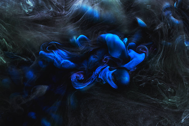 Blue black contrast liquid art background. Paint ink explosion, abstract clouds of smoke mock-up, watercolor underwater - Photo, Image