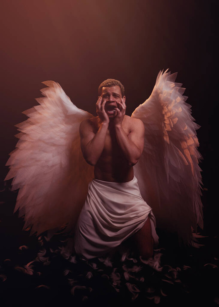 Young strong angel with white wings from heaven. Angel with muscular body. Sensual man - Foto, immagini