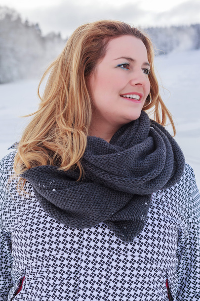 Portrait of a blond chubby woman in winter jacket and thick scarf. - Photo, Image