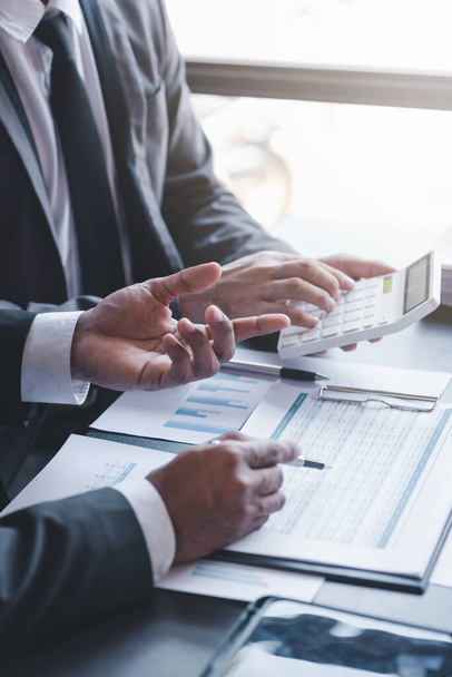 Finance and investment concept, Businessman present business finance investment plan with his partner, Investor colleagues discussing new investment plan by financial graph data on office table - Foto, Imagem