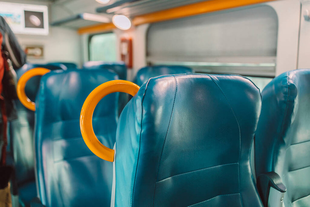 Empty seats in regional train with view through window in Europe. High quality photo - Zdjęcie, obraz
