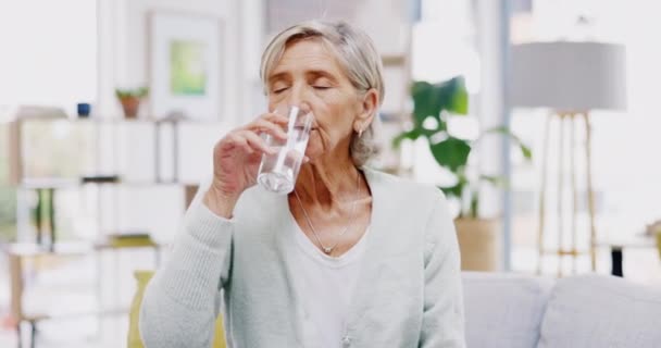 Wellness, home or healthy old woman drinking water for healthcare or natural vitamins in a house. Retirement, elderly relaxing or thirsty senior person refreshing with liquid for energy or hydration. - Footage, Video