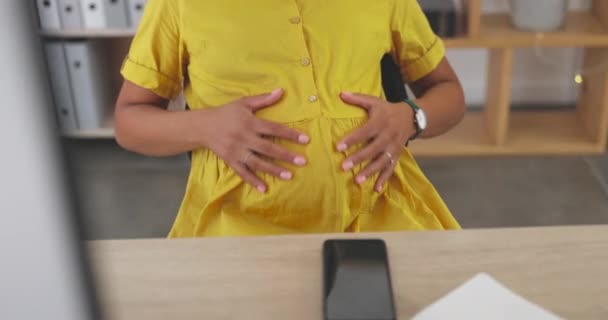 Touching belly, relax and a pregnant woman in the office, massaging stomach and break from work. Love, sitting and an employee feeling her tummy during pregnancy at the workplace for relaxation. - Footage, Video