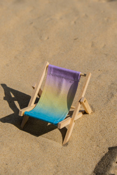 Sunny holidays on the beach sand beach accessories. Sun lounger stand sea. Wooden beach chairs. Summer holiday vacation concept. Copy space for your text  - 写真・画像