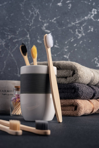 Bath accessories. Bathroom towels and bamboo toothbrushes.   - Fotografie, Obrázek
