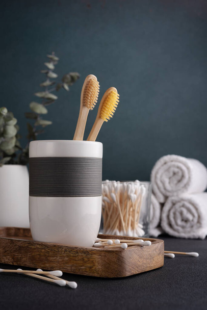 Bamboo toothbrush, towels and other bathroom accessories. Wellness and spa concept. - Φωτογραφία, εικόνα
