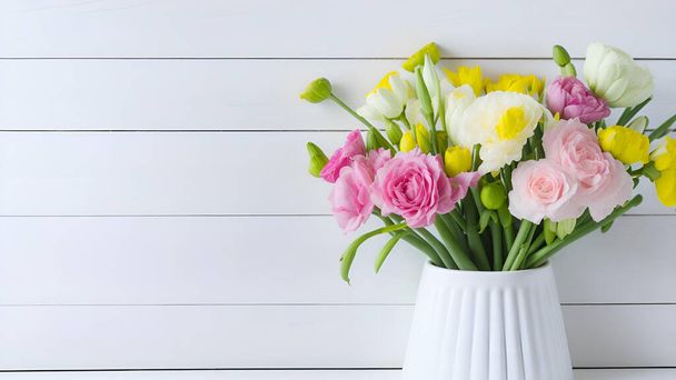 spring flower assortment in white vase in front of white wooden boarded wall, copy space, pastel colors, mother's day, valentines day, wedding, birthday - Photo, Image