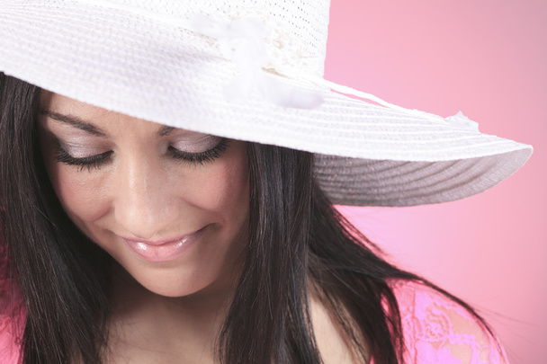 Gorgeous woman wearing a white garden hat. - 写真・画像