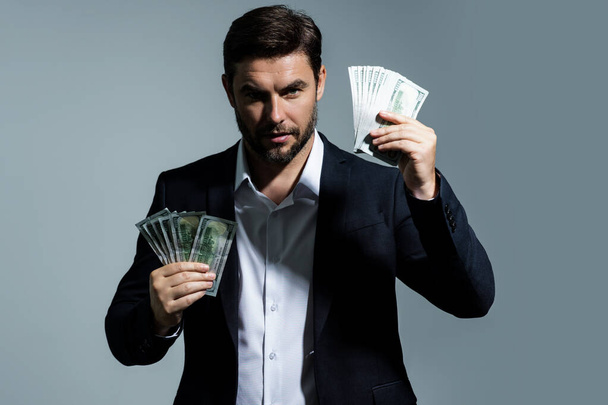 Man with money cash. Dollar banknotes. Portrait of man holding bunch of money banknotes. Dollar bills, credit, online banking. Rich man with dollar banknotes, bank loan, financial savings - Foto, immagini