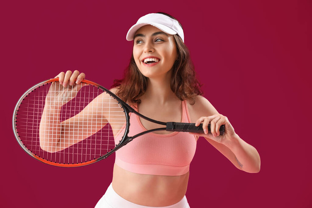 Young woman with tennis racket on pink background - Zdjęcie, obraz