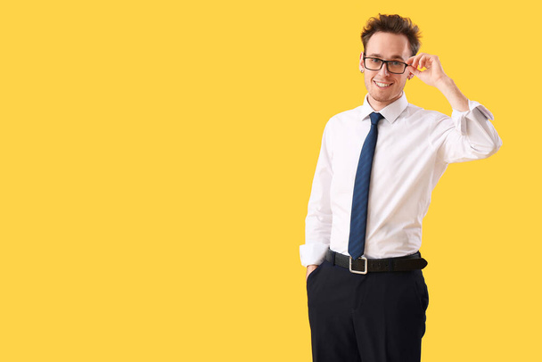 Young businessman on yellow background - Photo, image